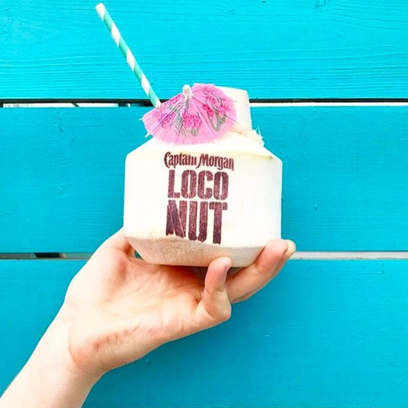 A coconut branded with a Captain Morgan logo using a coconut branding iron