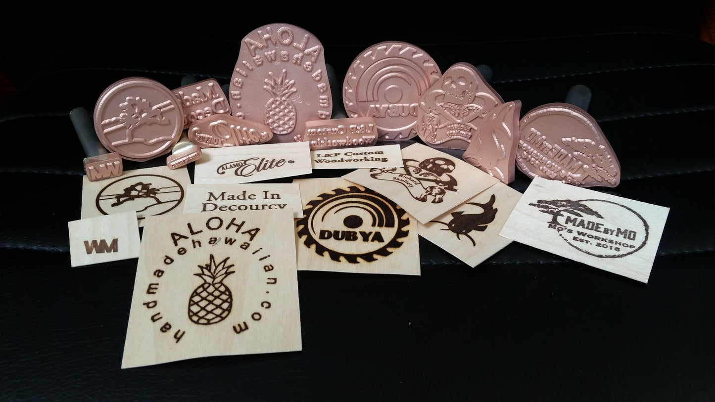 Collection of custom branding irons on a dark background