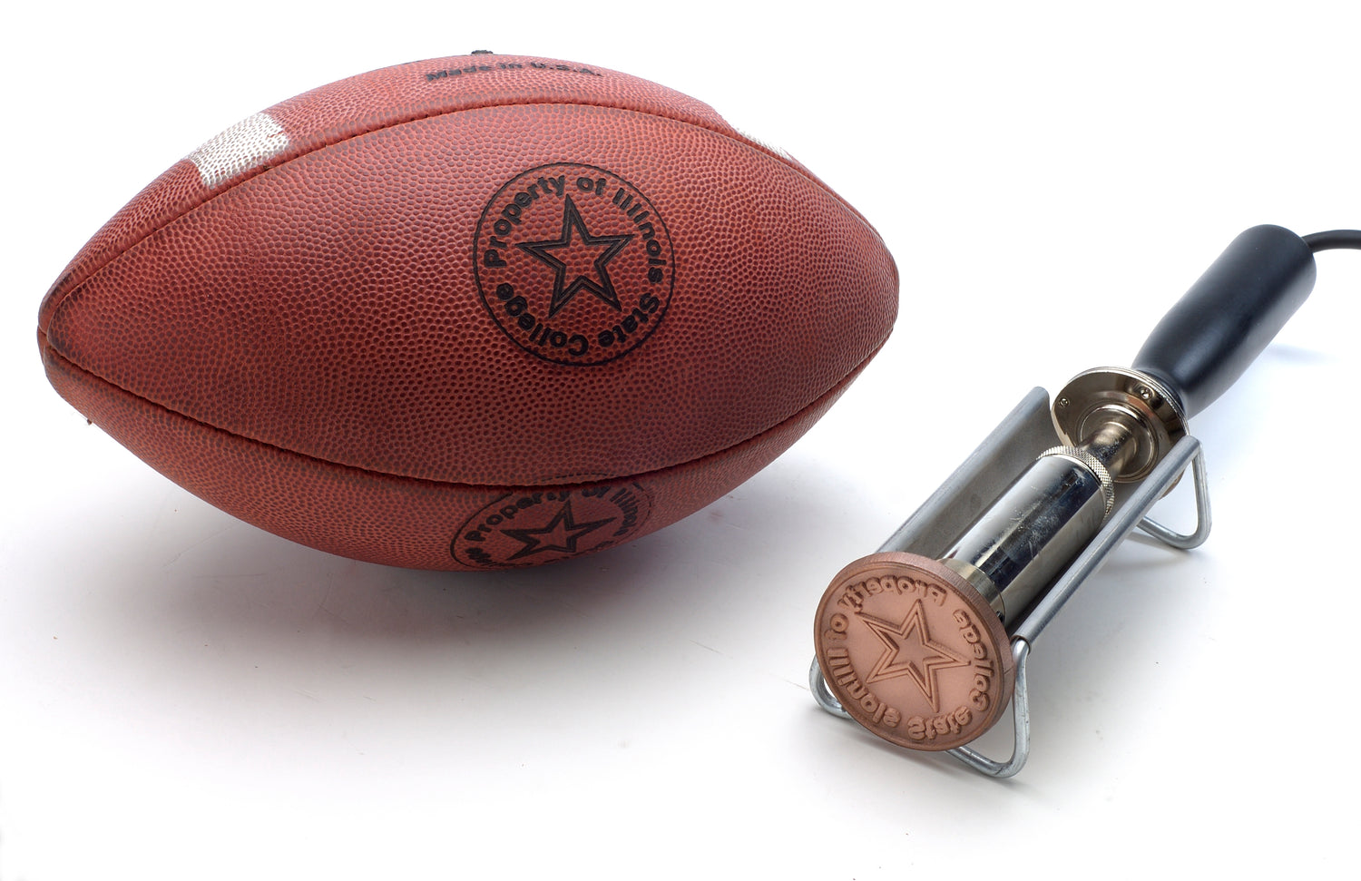 a football branded with a detailed logo and an electric football branding iron